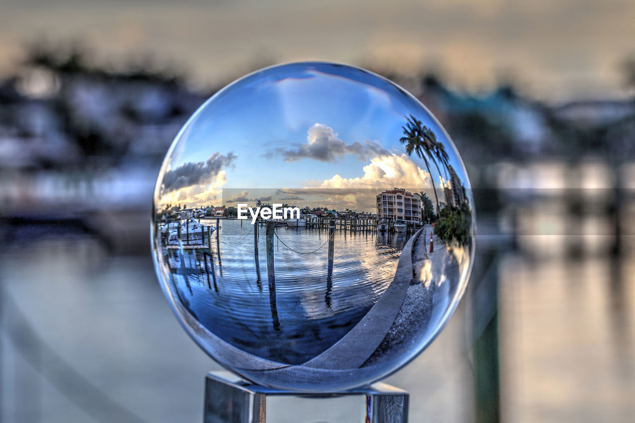 Crystal ball of boats docked at a marina near venetian bay in naples, florida at sunrise.