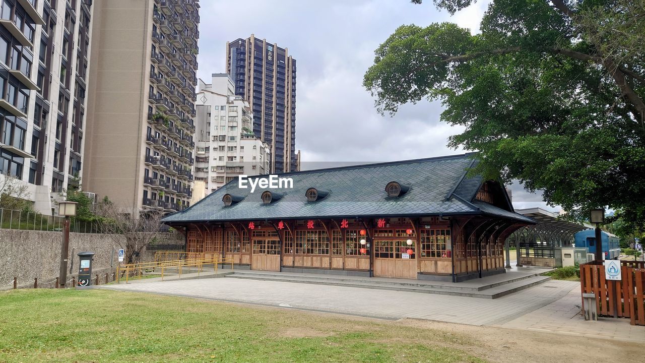 architecture, building exterior, built structure, building, city, plant, tree, sky, nature, neighbourhood, downtown, office building exterior, residential district, street, cloud, travel destinations, residential area, no people, urban area, outdoors, landscape, day, skyscraper, travel, estate, city life, grass, office