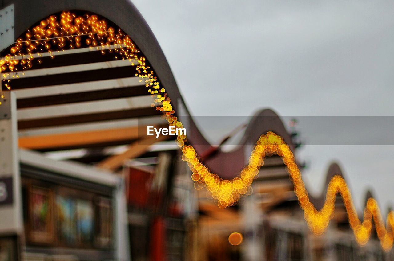 Defocused image of illuminated christmas lights on building