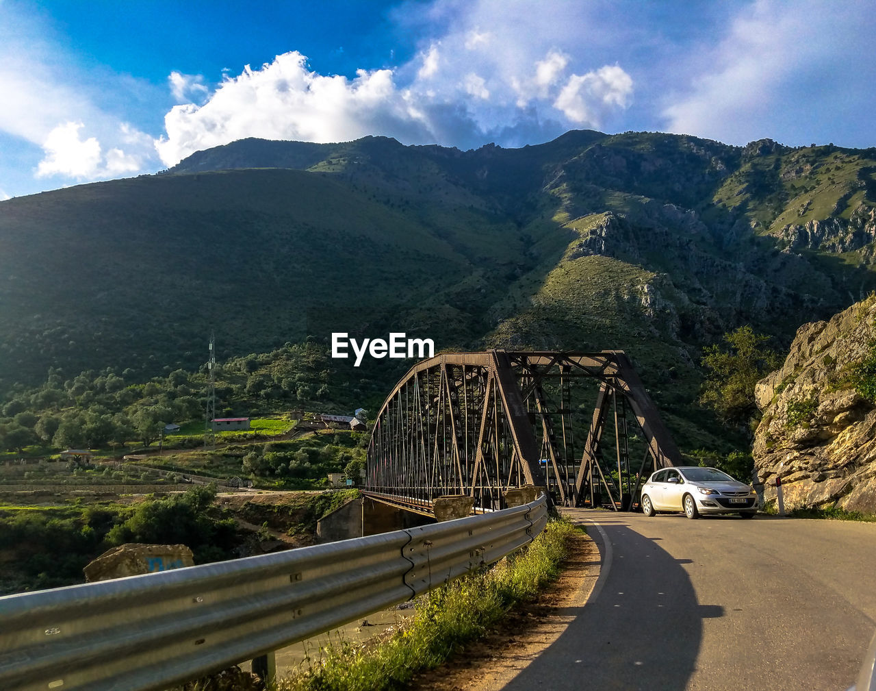 Road by mountain against sky