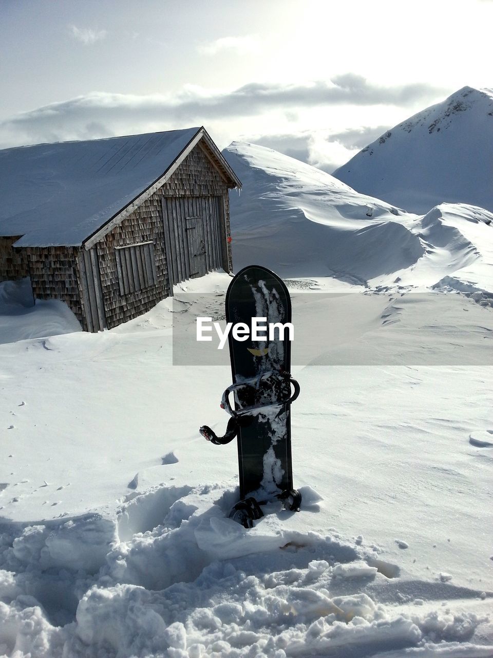 Snowboard sticking out from snow