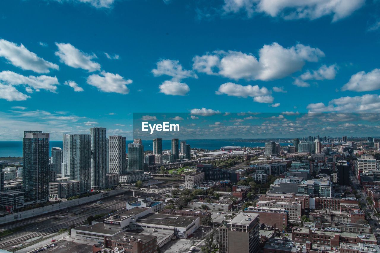 HIGH ANGLE VIEW OF CITY AGAINST SKY