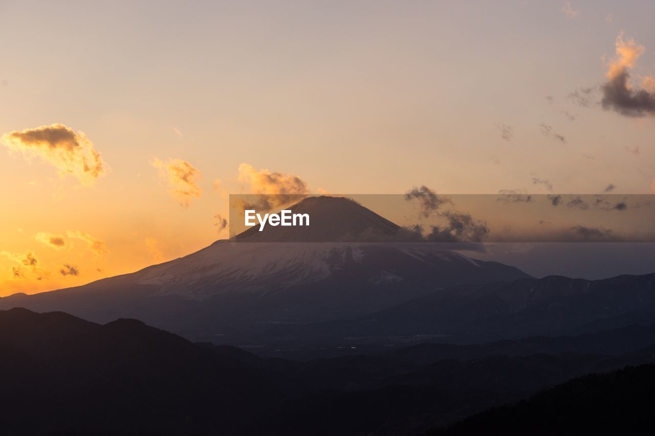 Scenic view of silhouette mountains against sky during sunset