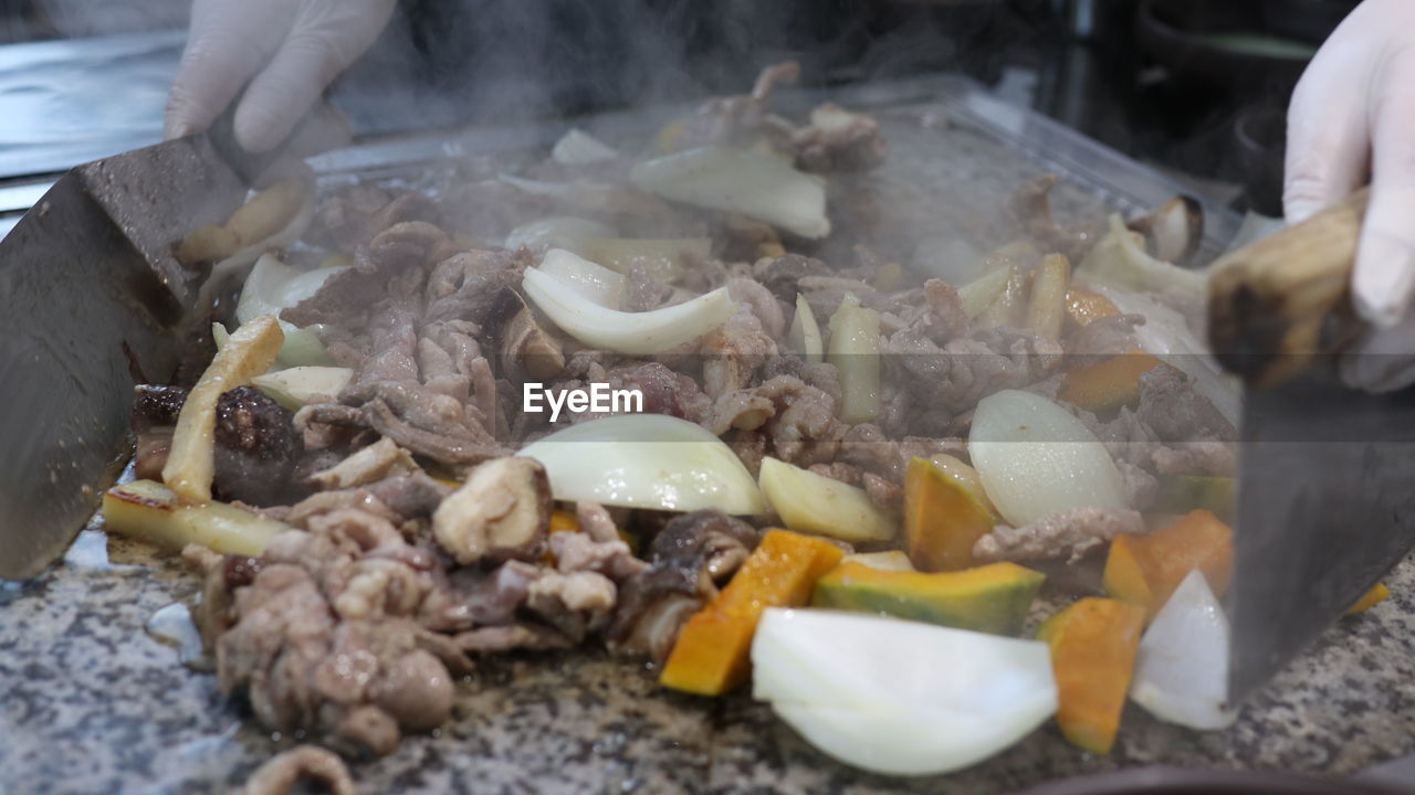 Duck, pumpkin and mushrooms grilled on a stone plate. korean cuisine.