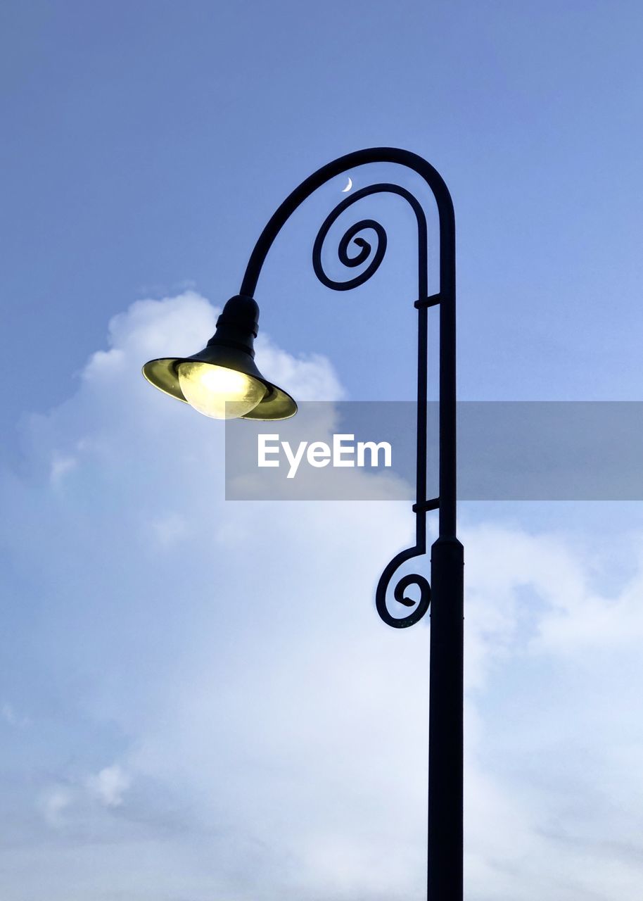 LOW ANGLE VIEW OF STREET LIGHT HANGING AGAINST SKY