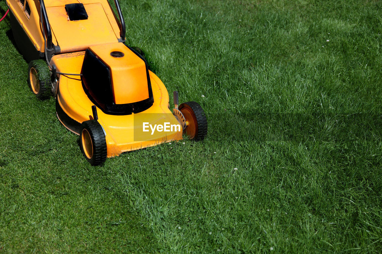 High angle view of lawn mower on grassy field