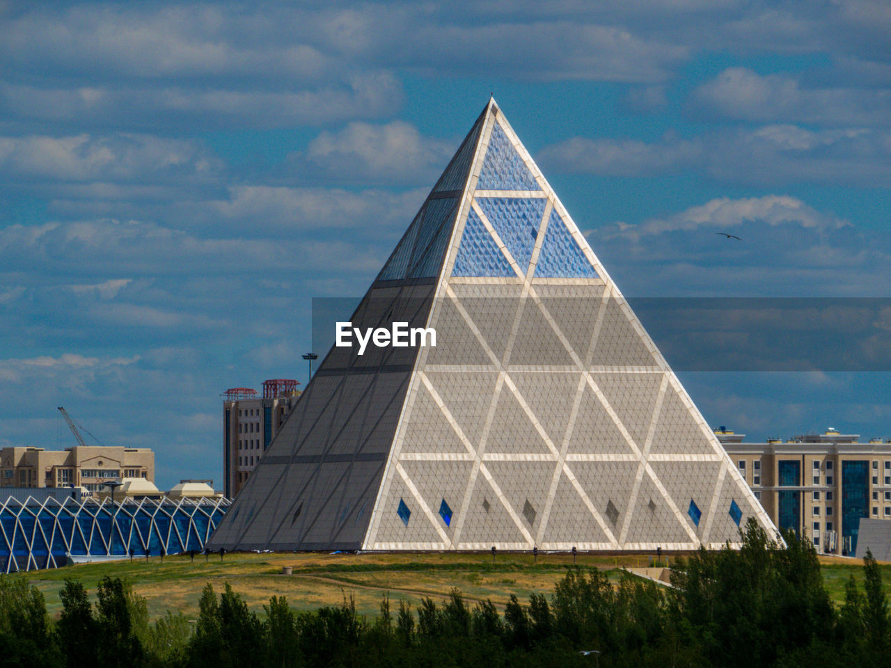 BUILDING AGAINST CLOUDY SKY