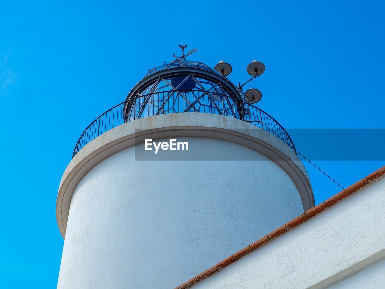 Low angle view of water tower against clear blue sky