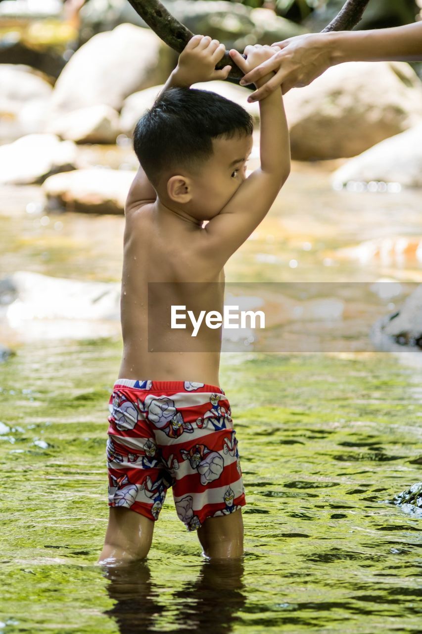 BOY LOOKING AT WATER