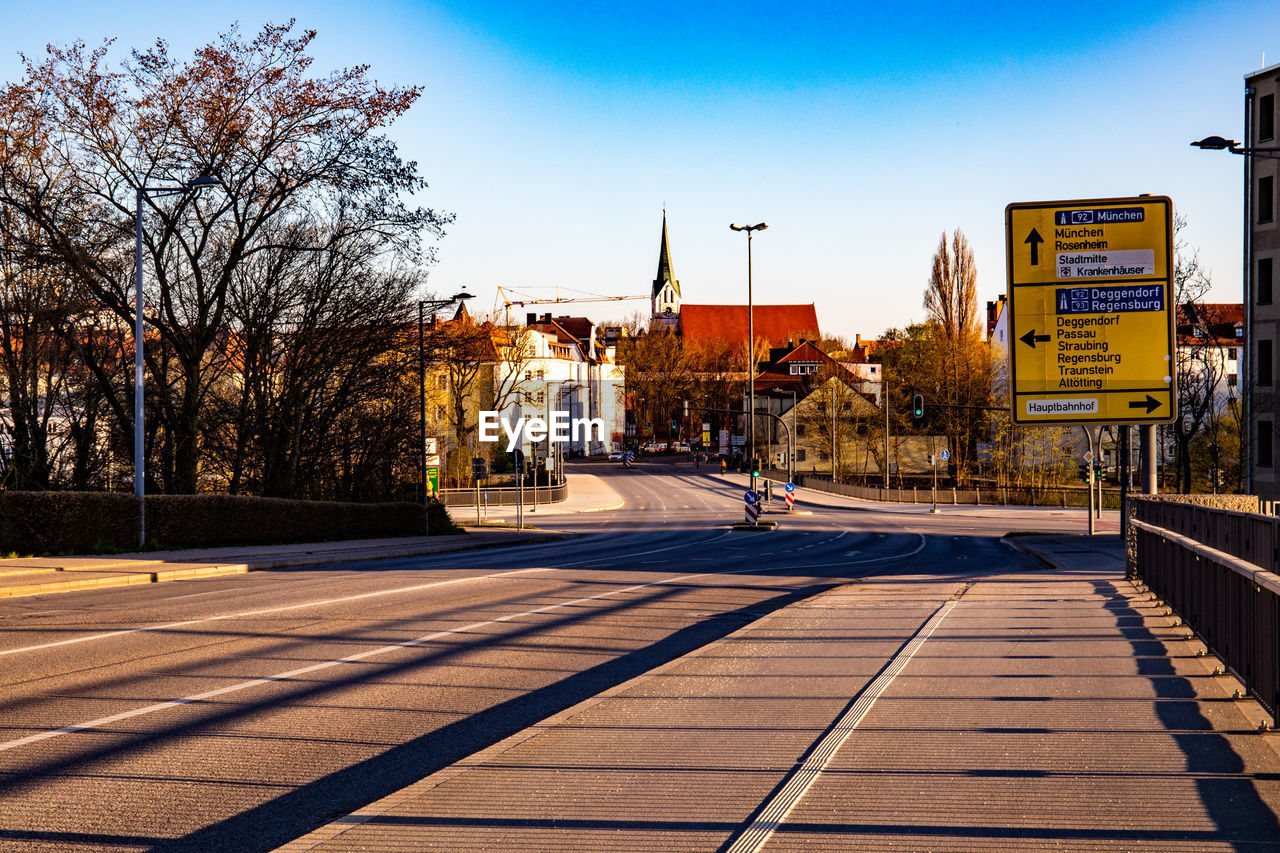 ROAD BY BUILDINGS AGAINST SKY