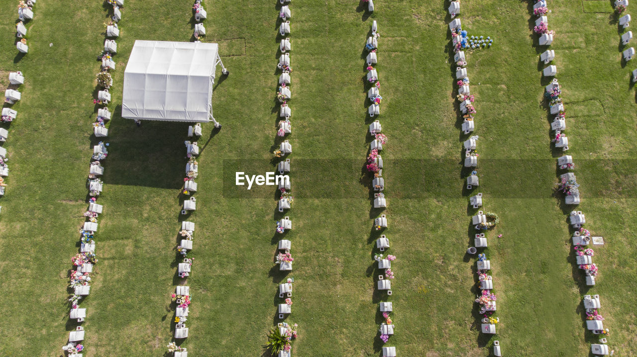 Aerial view of tombstone on field during sunny day