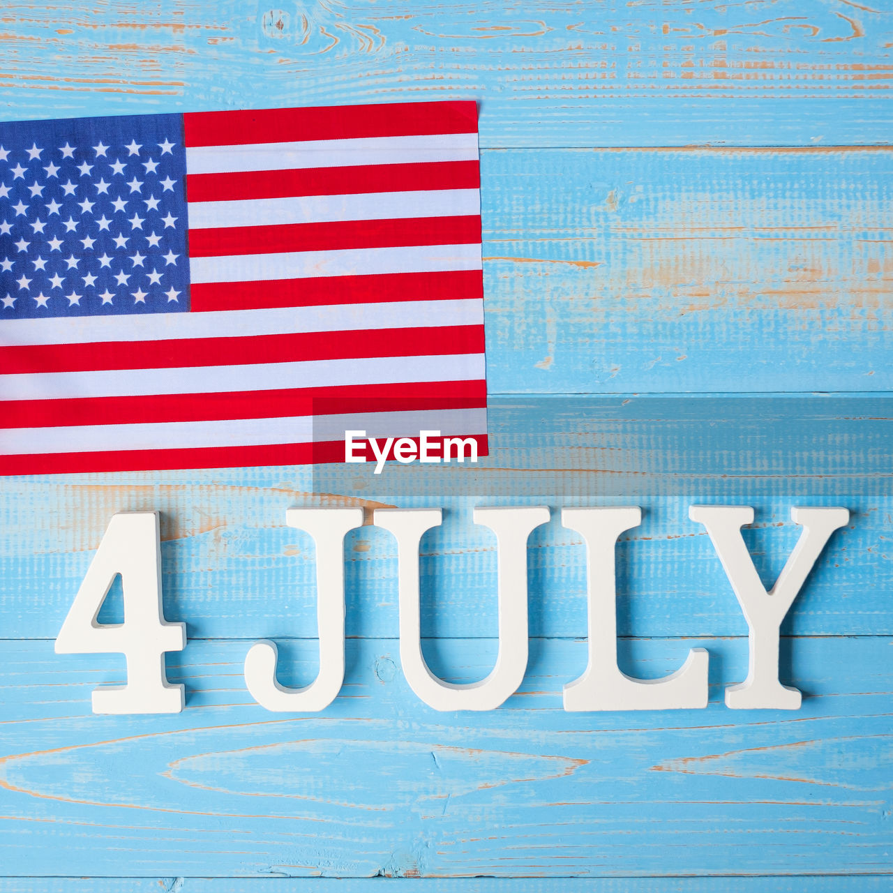 DIRECTLY ABOVE SHOT OF FLAG ON BLUE WALL