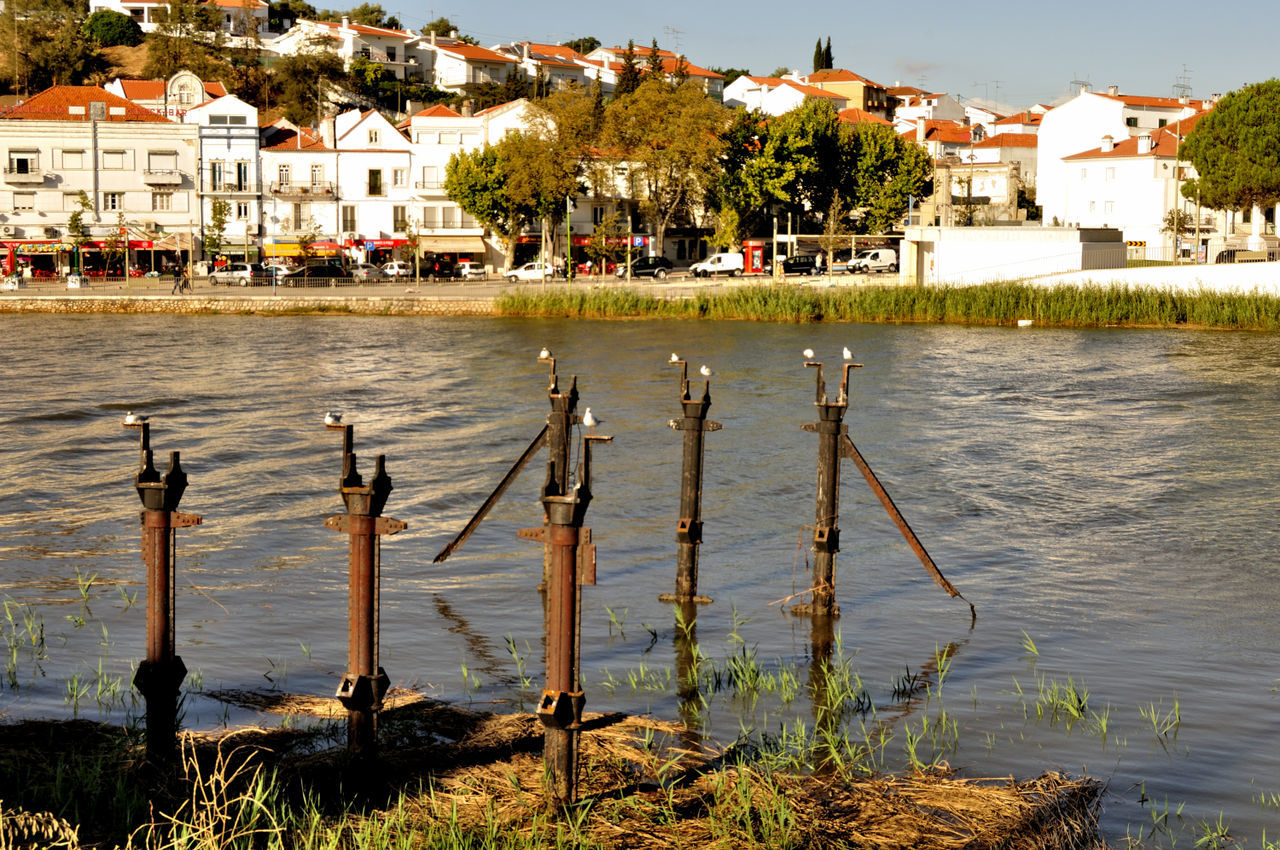 Scenic view of lake against houses