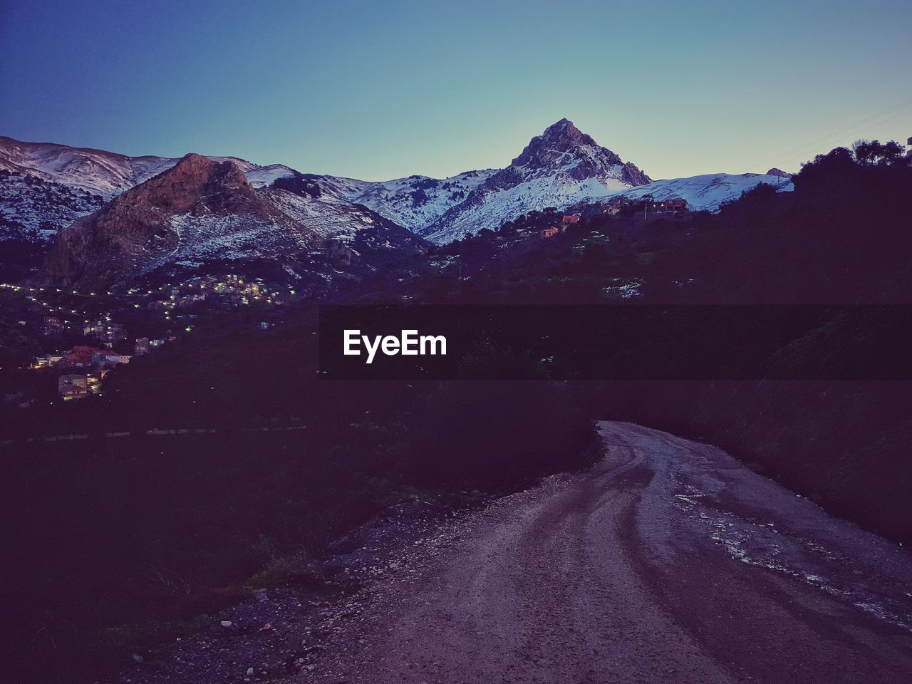 Scenic view of snowcapped mountains against clear sky