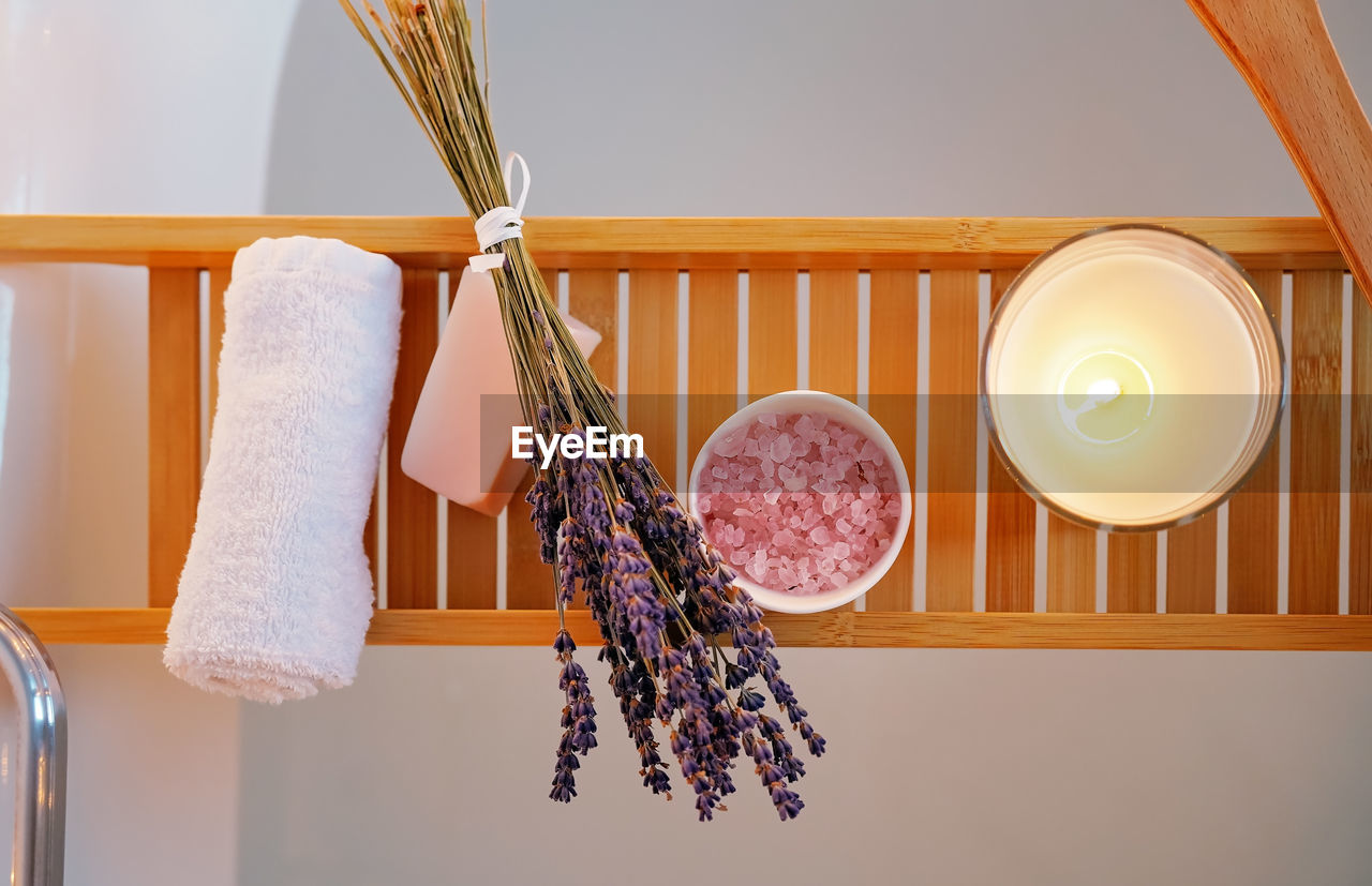 Spiritual aura cleansing ritual bath for full moon ritual. top view of candles, aroma salt lavender