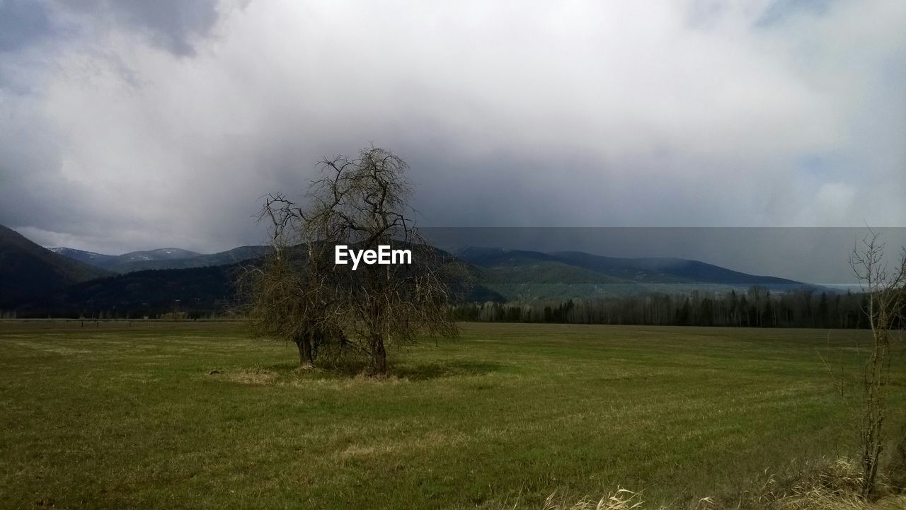 SCENIC VIEW OF MOUNTAINS AGAINST CLOUDY SKY