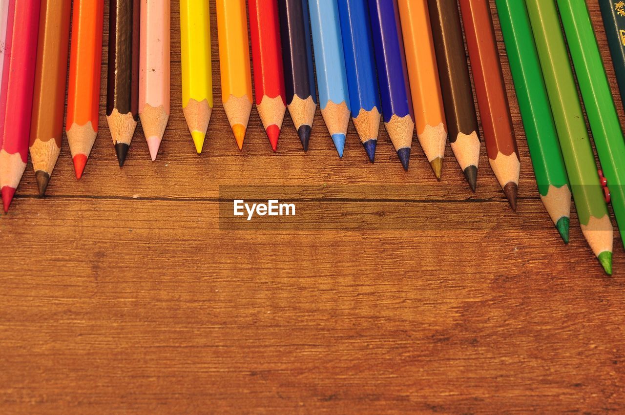 high angle view of colorful pencils on wooden table