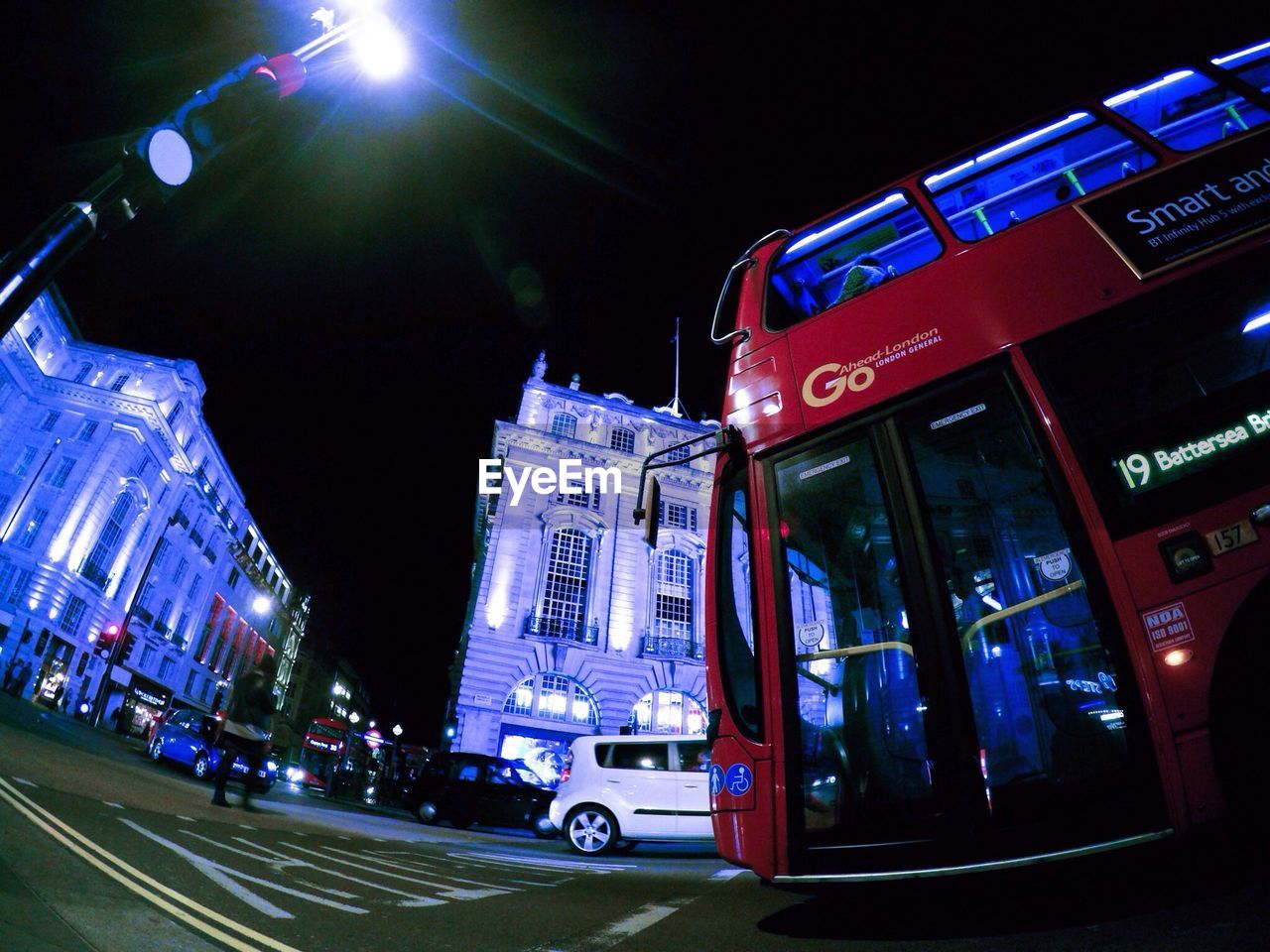 Low angle view of bus on illuminated city street at night