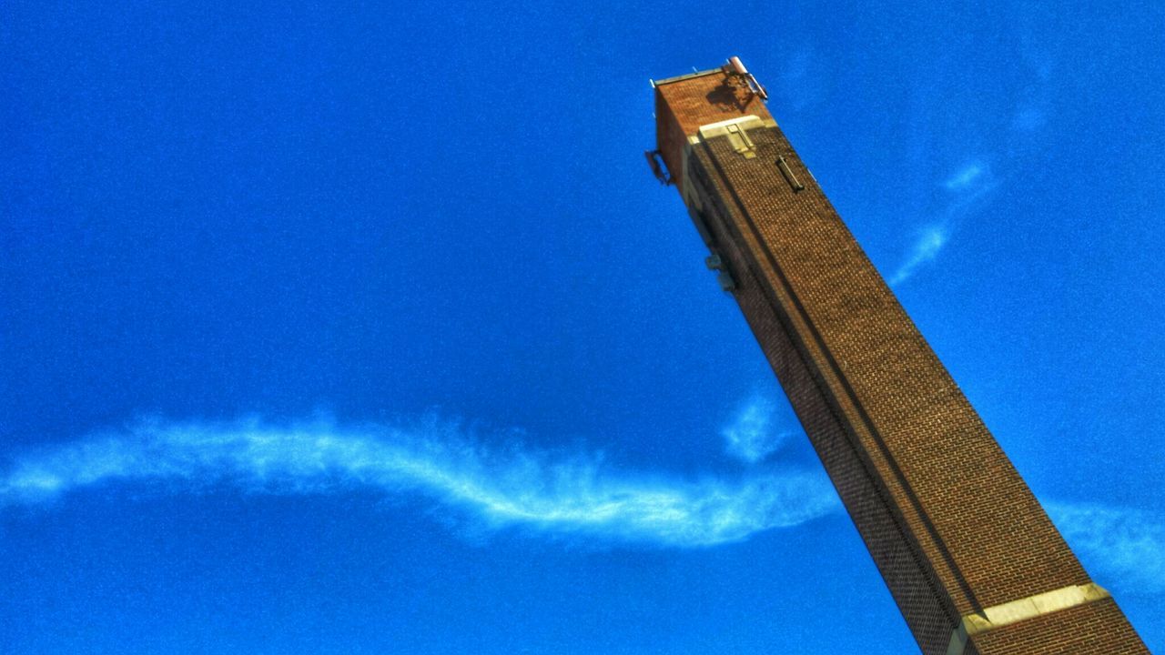 Tilt image of tower against blue sky