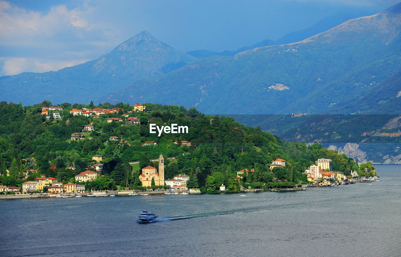 High angle view of boat moving in lake como against mountains