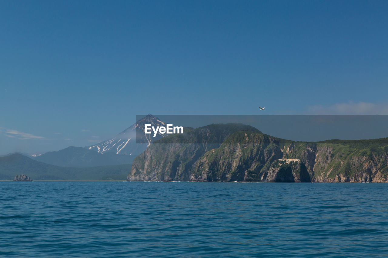 Scenic view of sea against blue sky