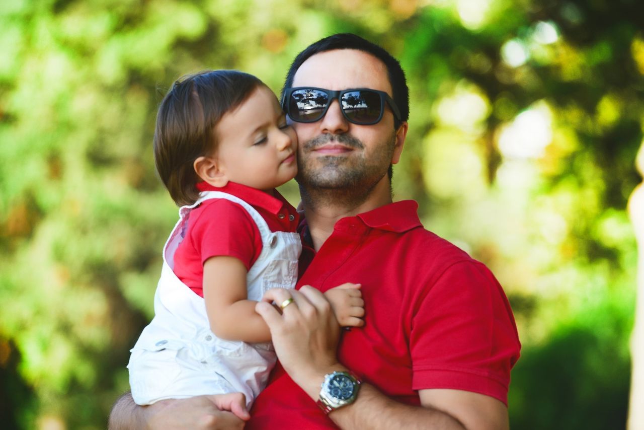 Portrait of man carrying boy