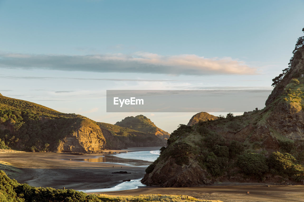 Scenic view of sea and mountains against sky