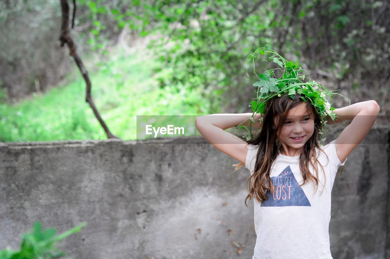 Smiling girl wearing plant