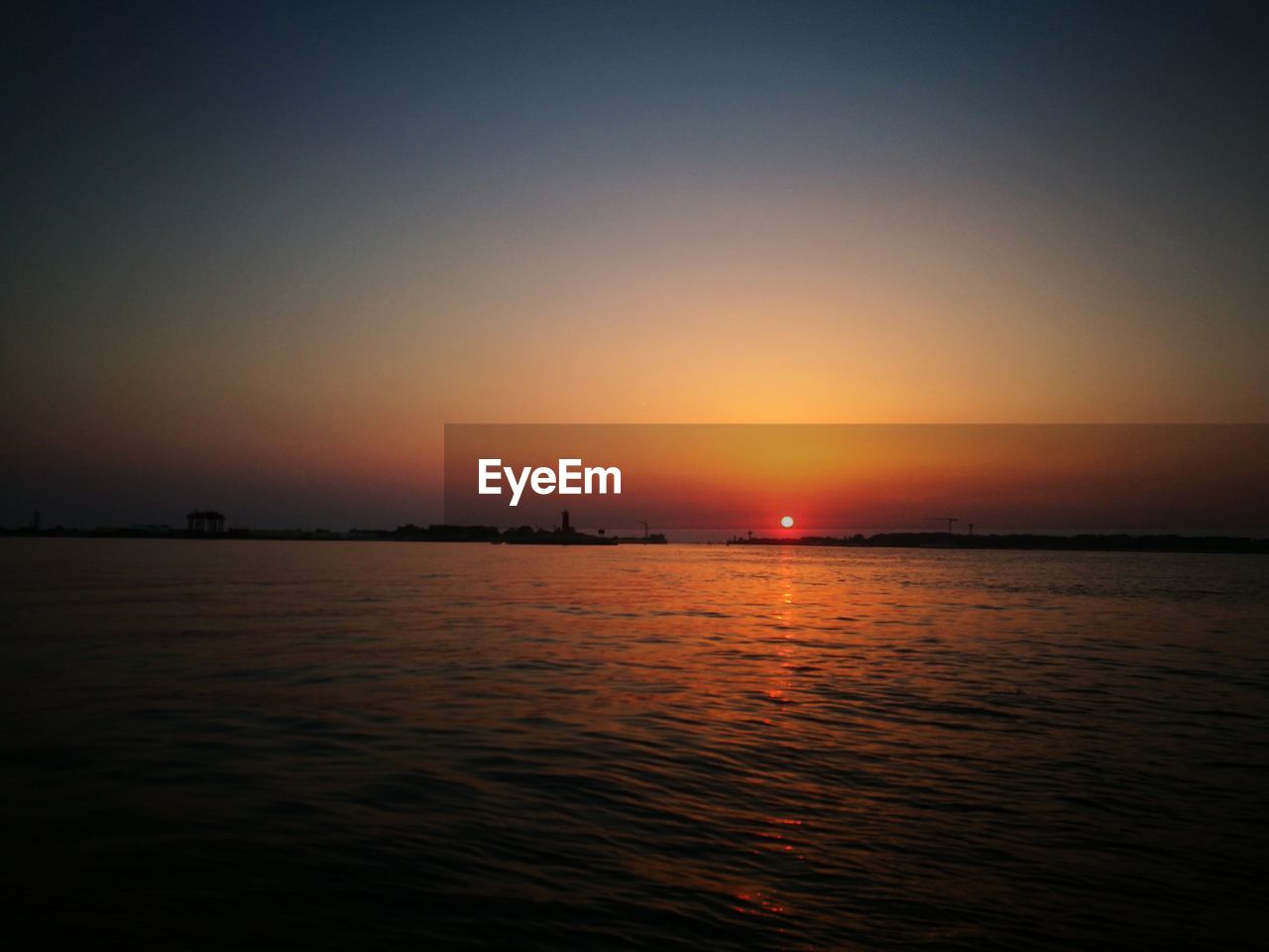 Scenic view of sea against clear sky during sunset