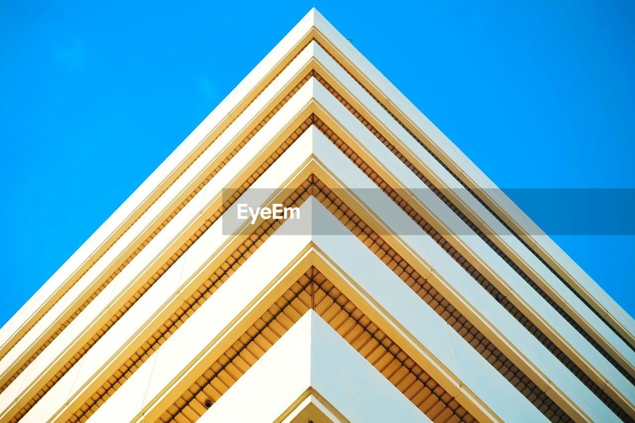 Low angle view of building against clear blue sky