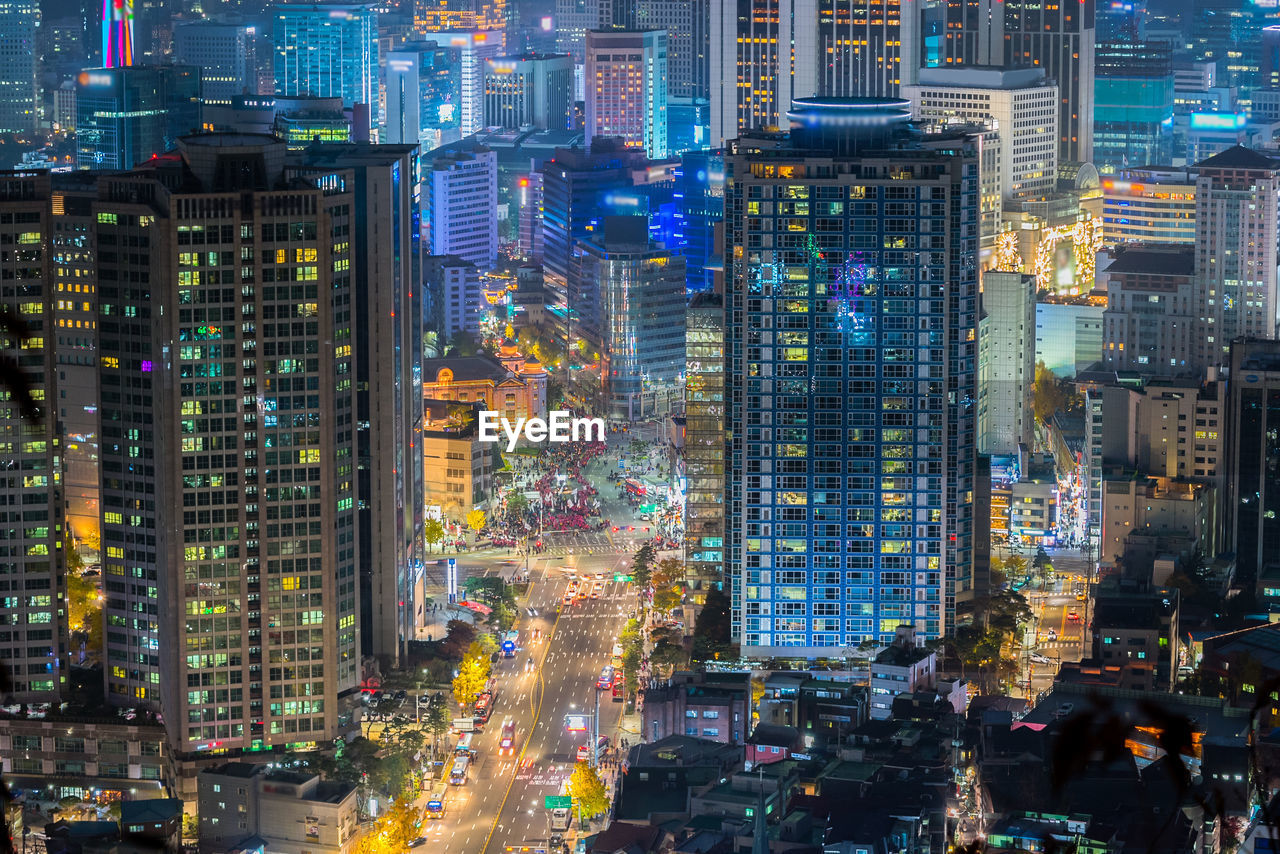 Aerial view of city lit up at night