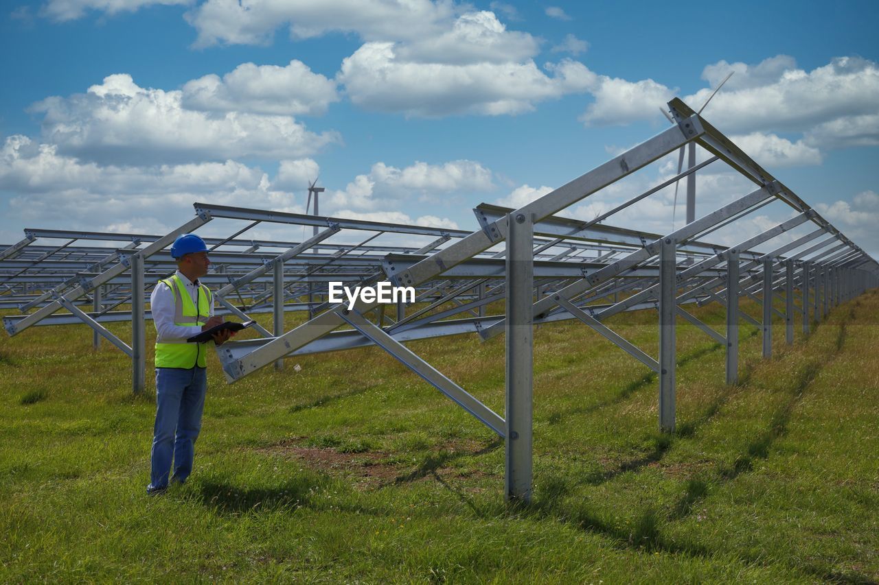 Full length of man standing on field against sky
