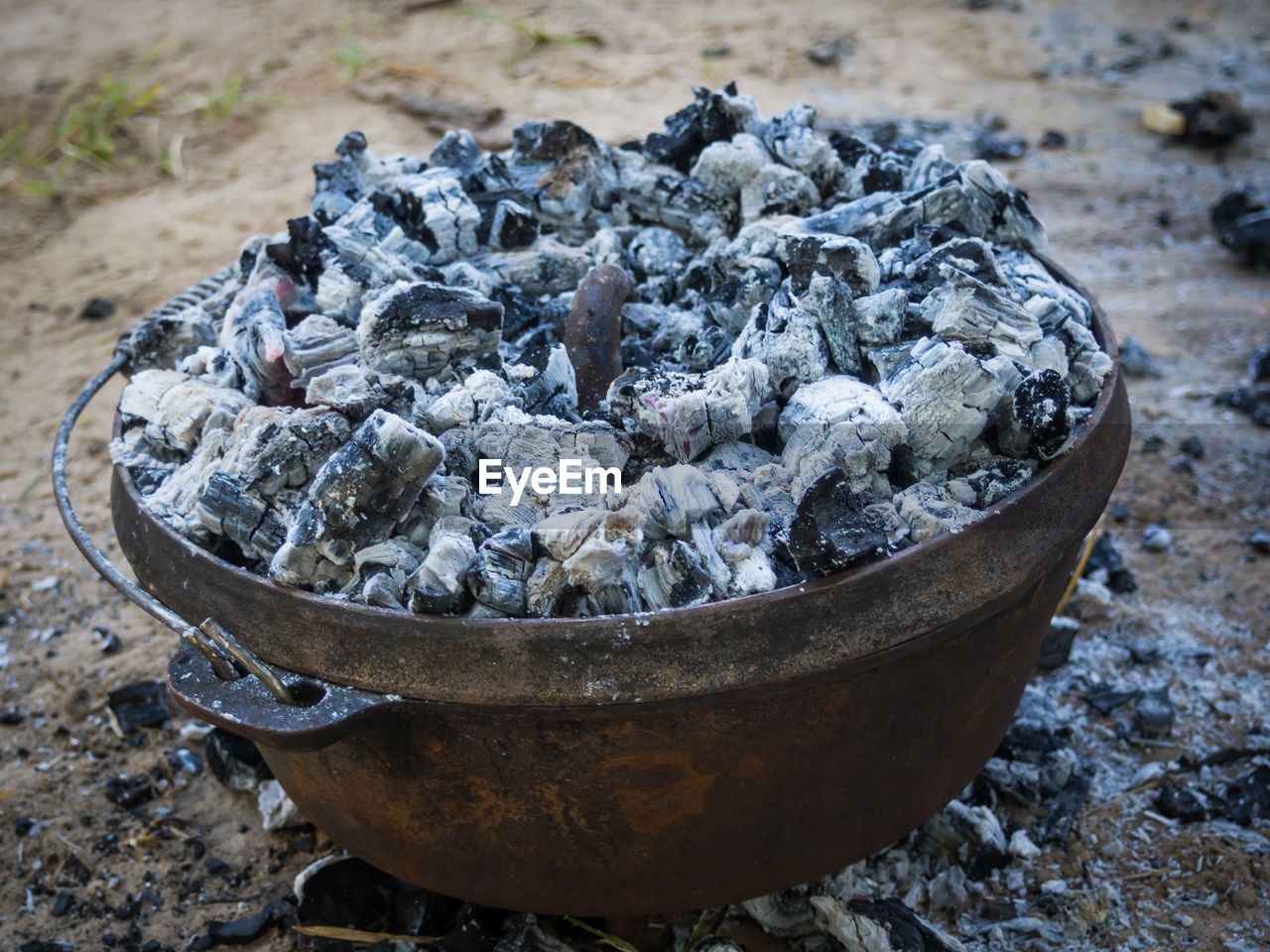 High angle view of cast iron pot with coal