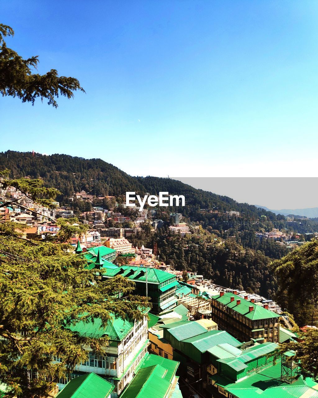 High angle view of townscape against clear blue sky