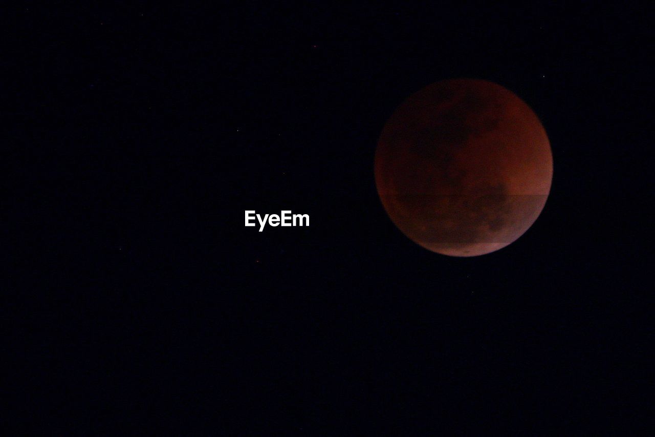 LOW ANGLE VIEW OF MOON IN SKY