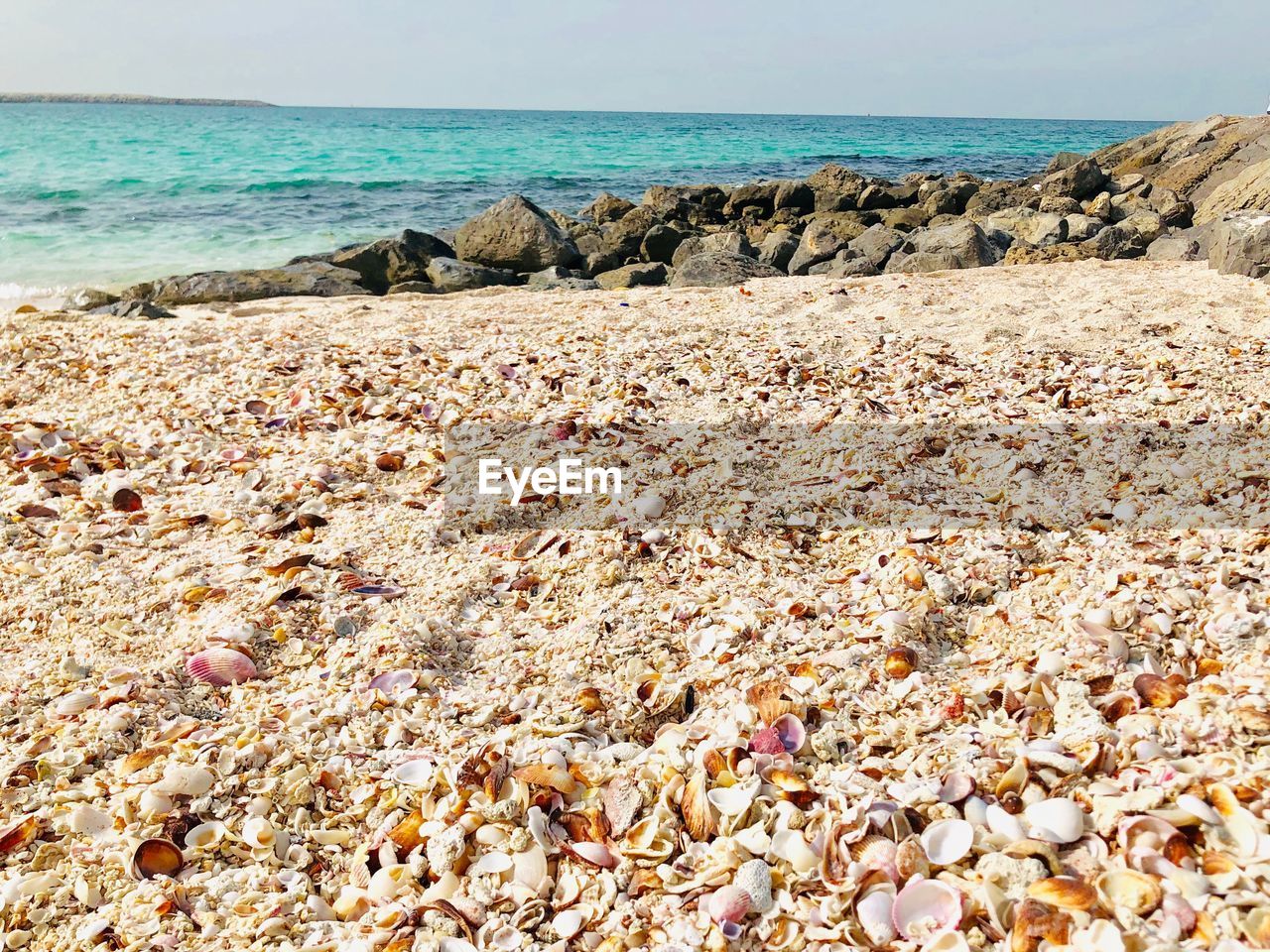 Rocks on beach against sky