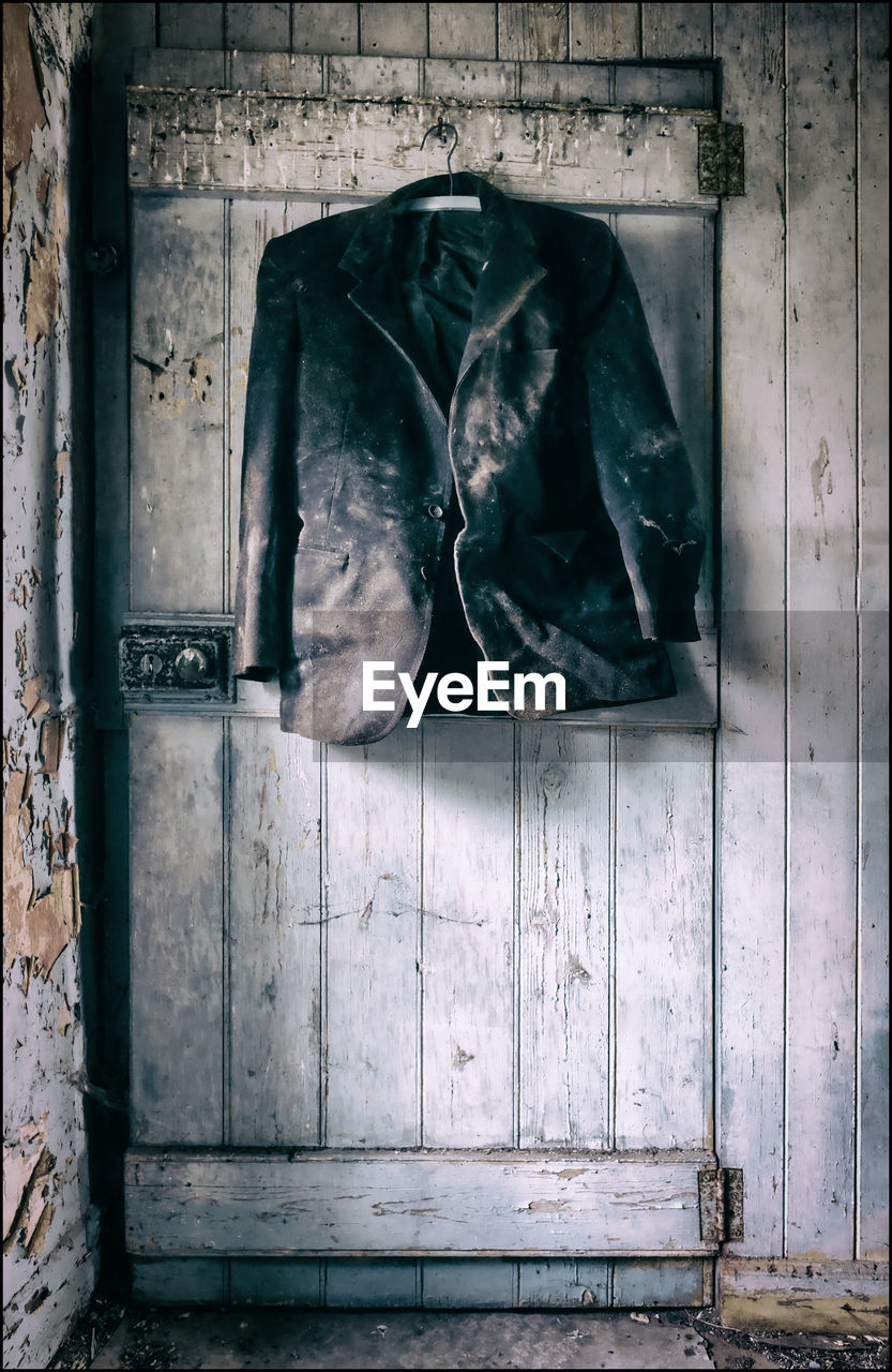 Old coat hanging on door