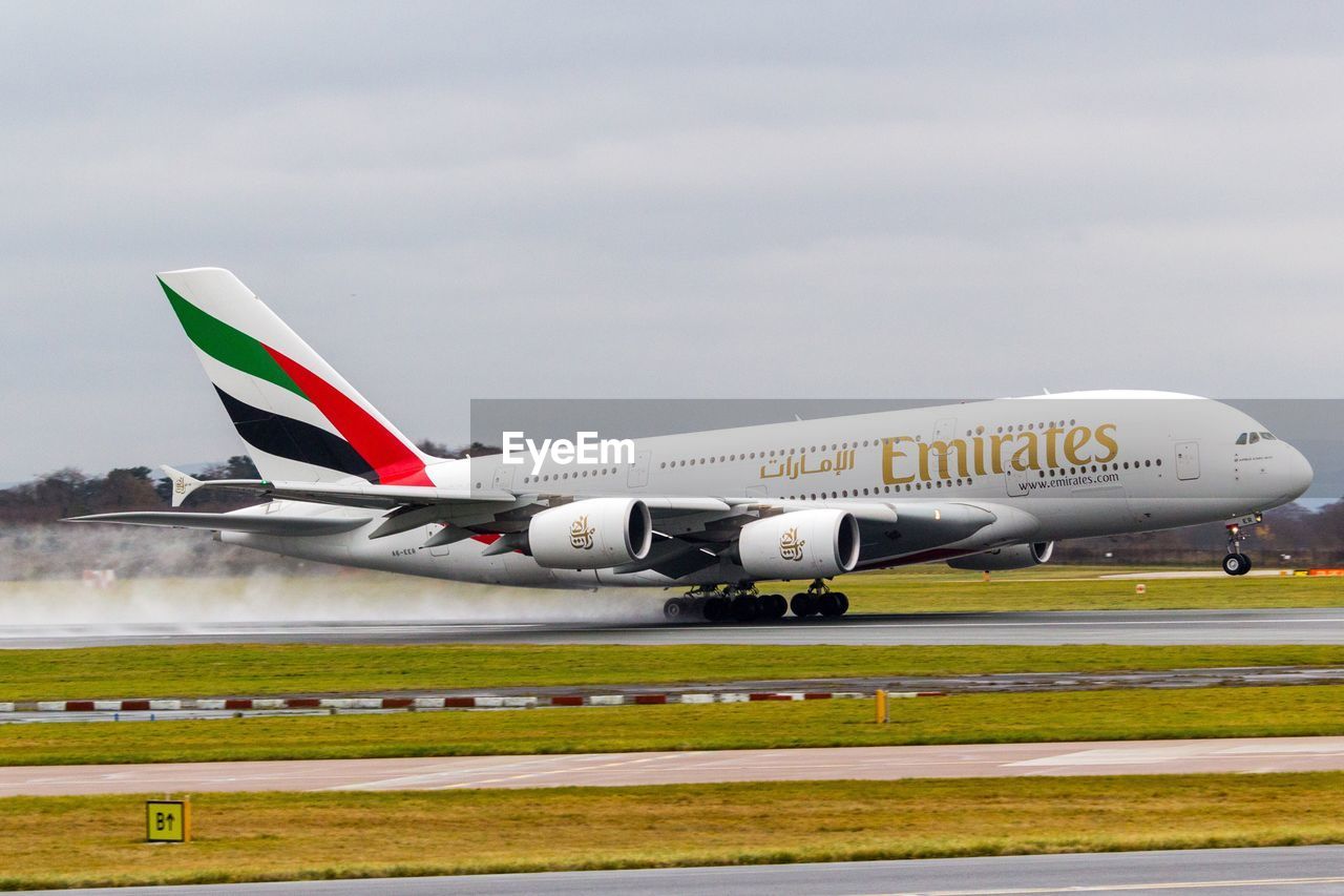 AIRPLANE ON RUNWAY AGAINST SKY