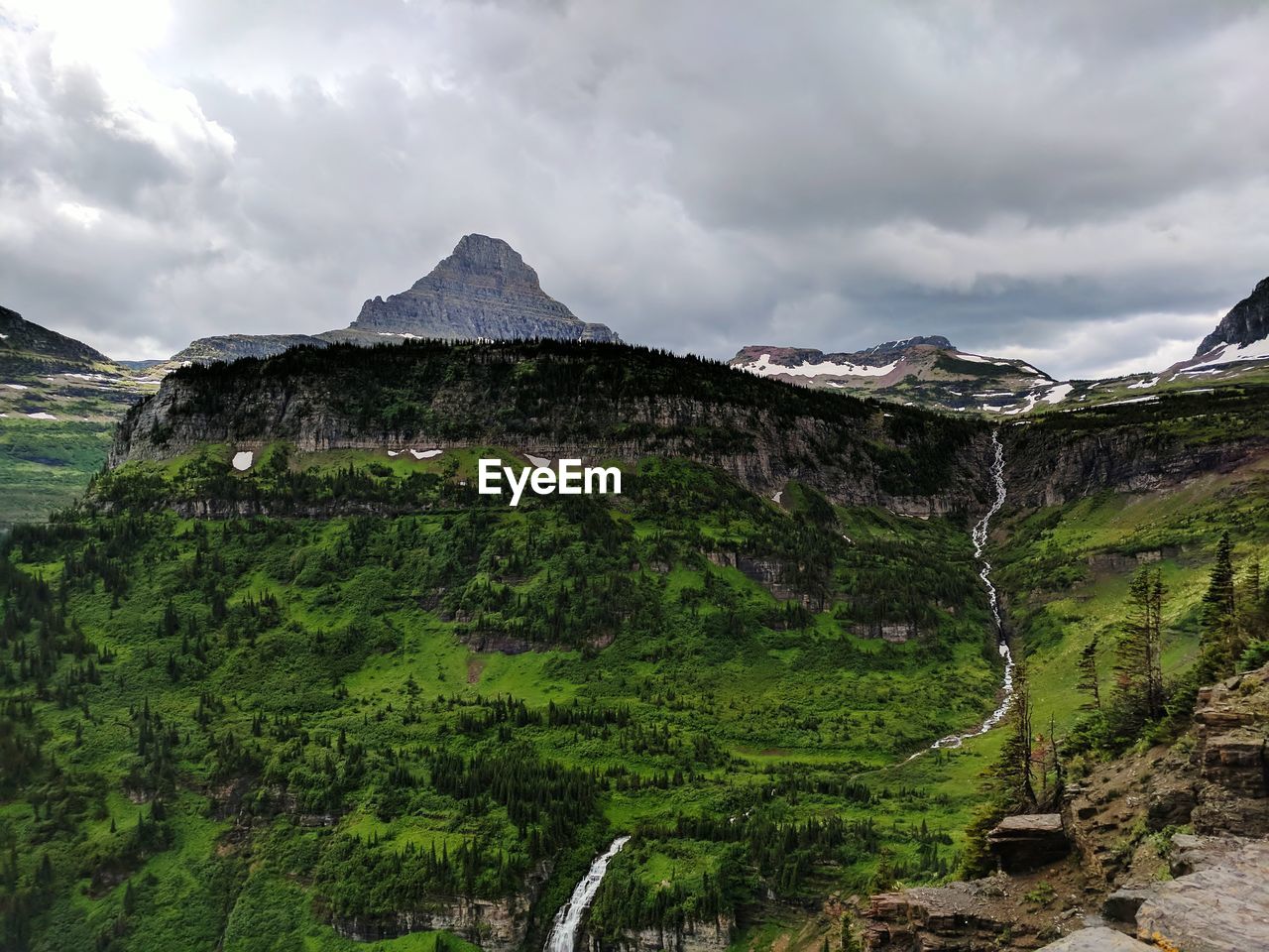 PANORAMIC SHOT OF LAND AND MOUNTAINS AGAINST SKY