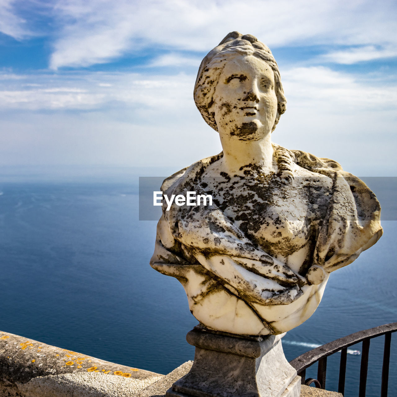 STATUE AGAINST SEA AGAINST SKY