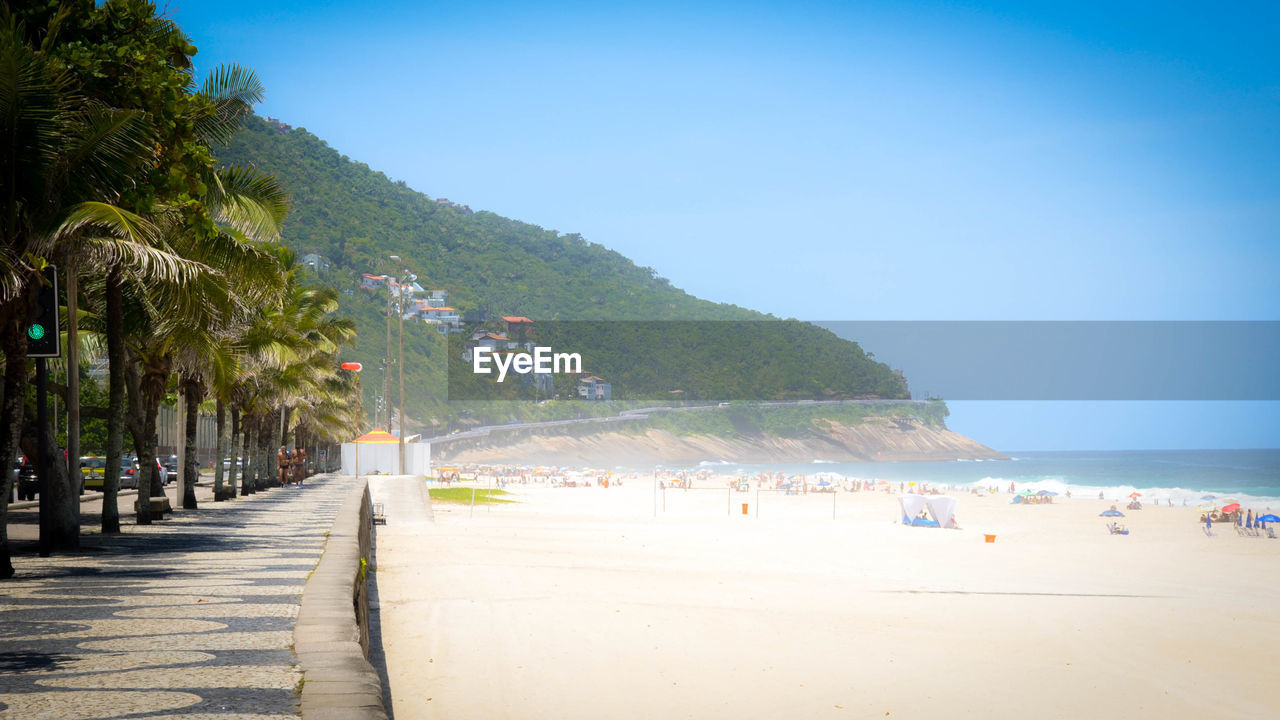 VIEW OF BEACH AGAINST CLEAR BLUE SKY