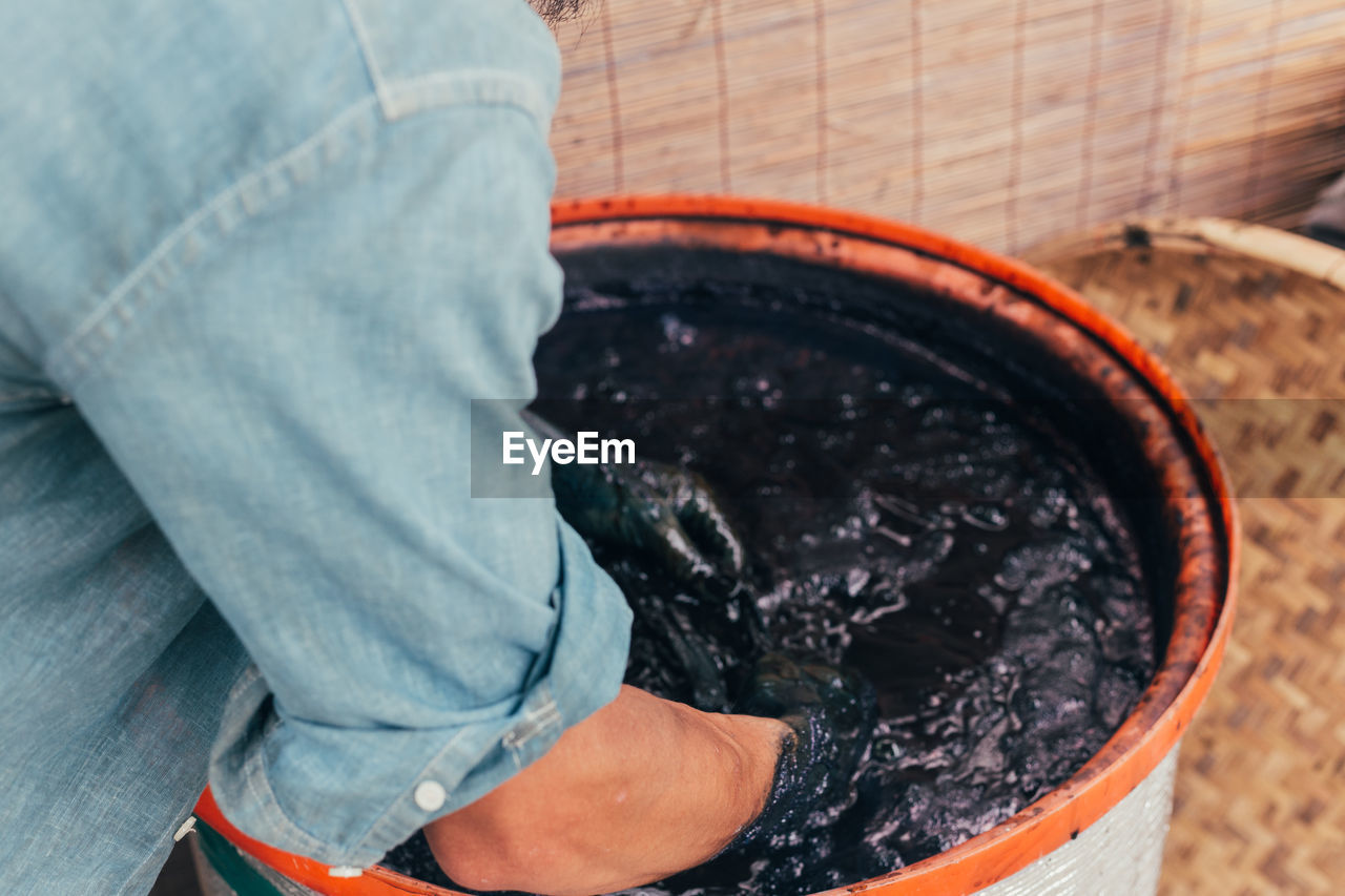 Midsection of man working in dye