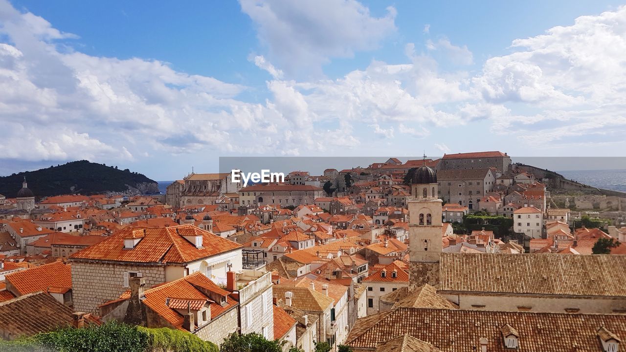 View of town against cloudy sky