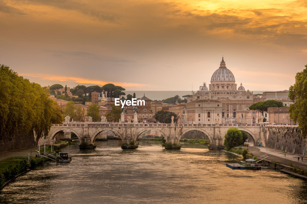 Ponte sant angelo over tiber river during sunset in city