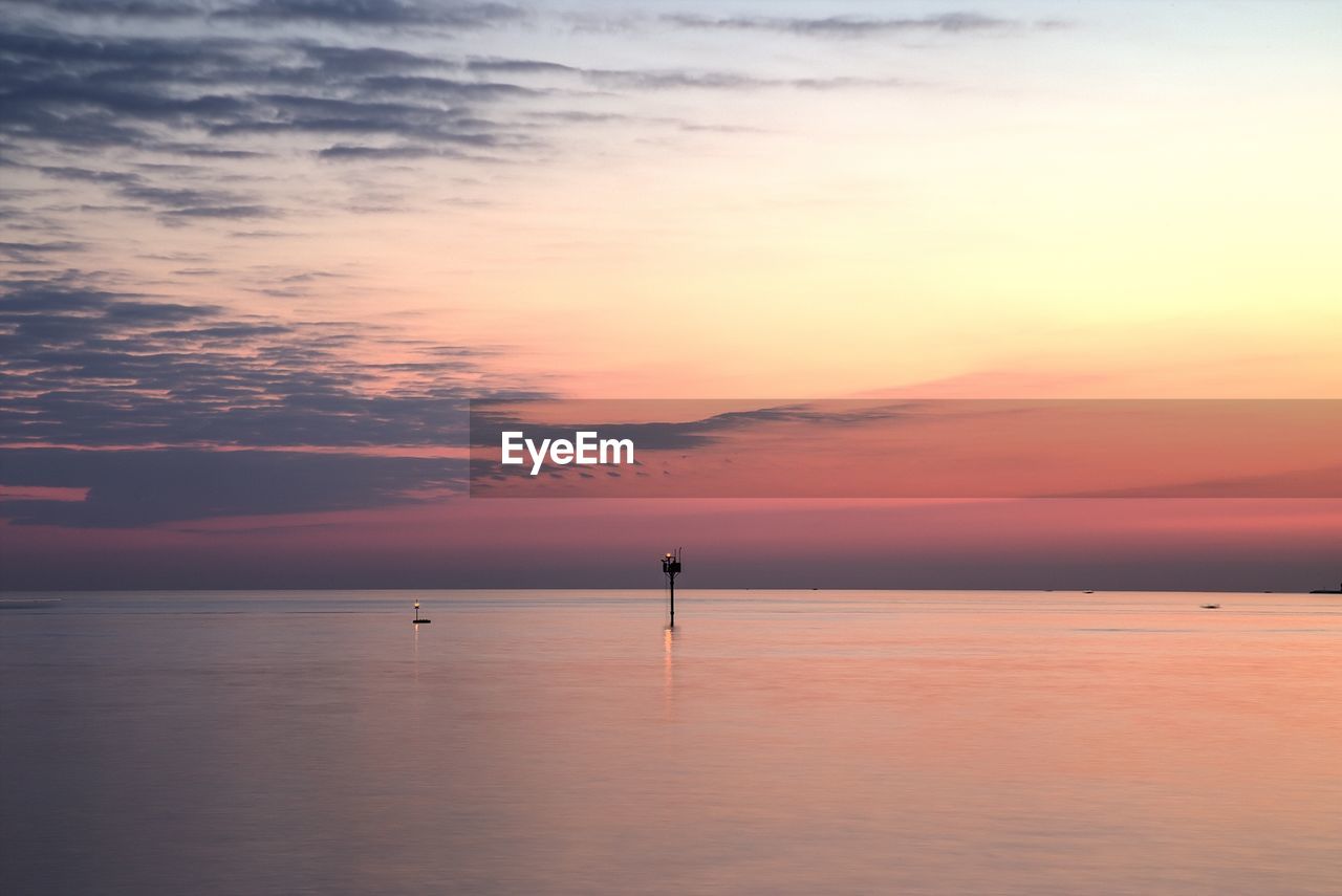 Scenic view of sea against sky at sunset