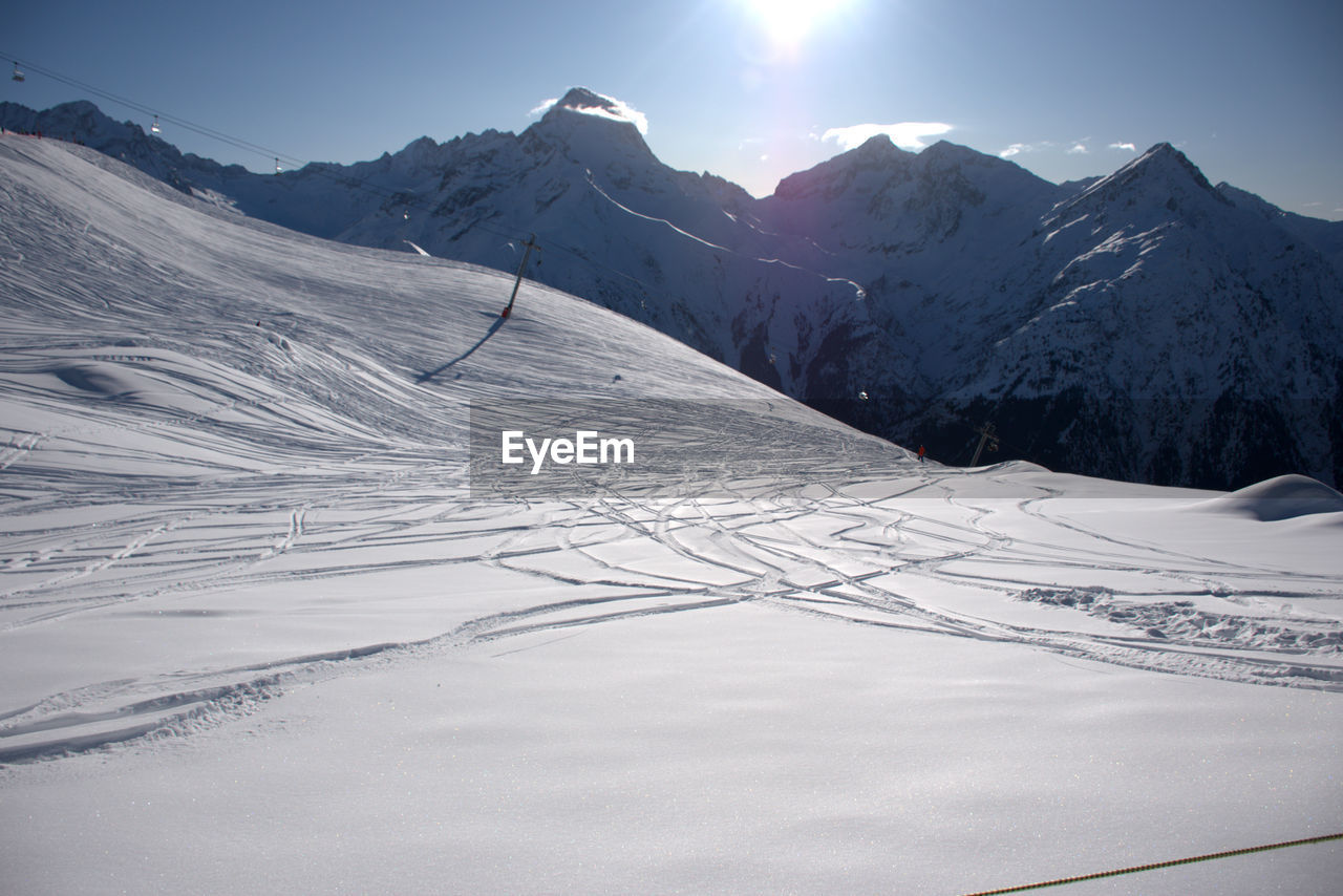 Scenic view of snow covered mountains against sky