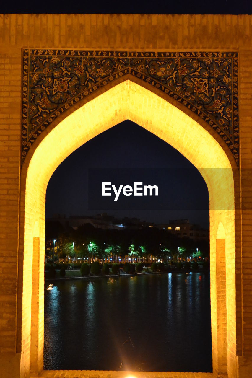 VIEW OF ILLUMINATED BRIDGE AT NIGHT