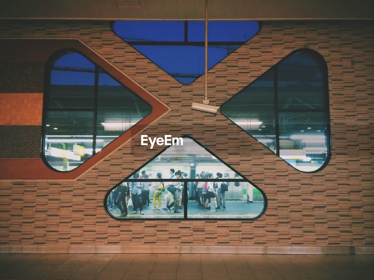 Group of people walking on railway station platform