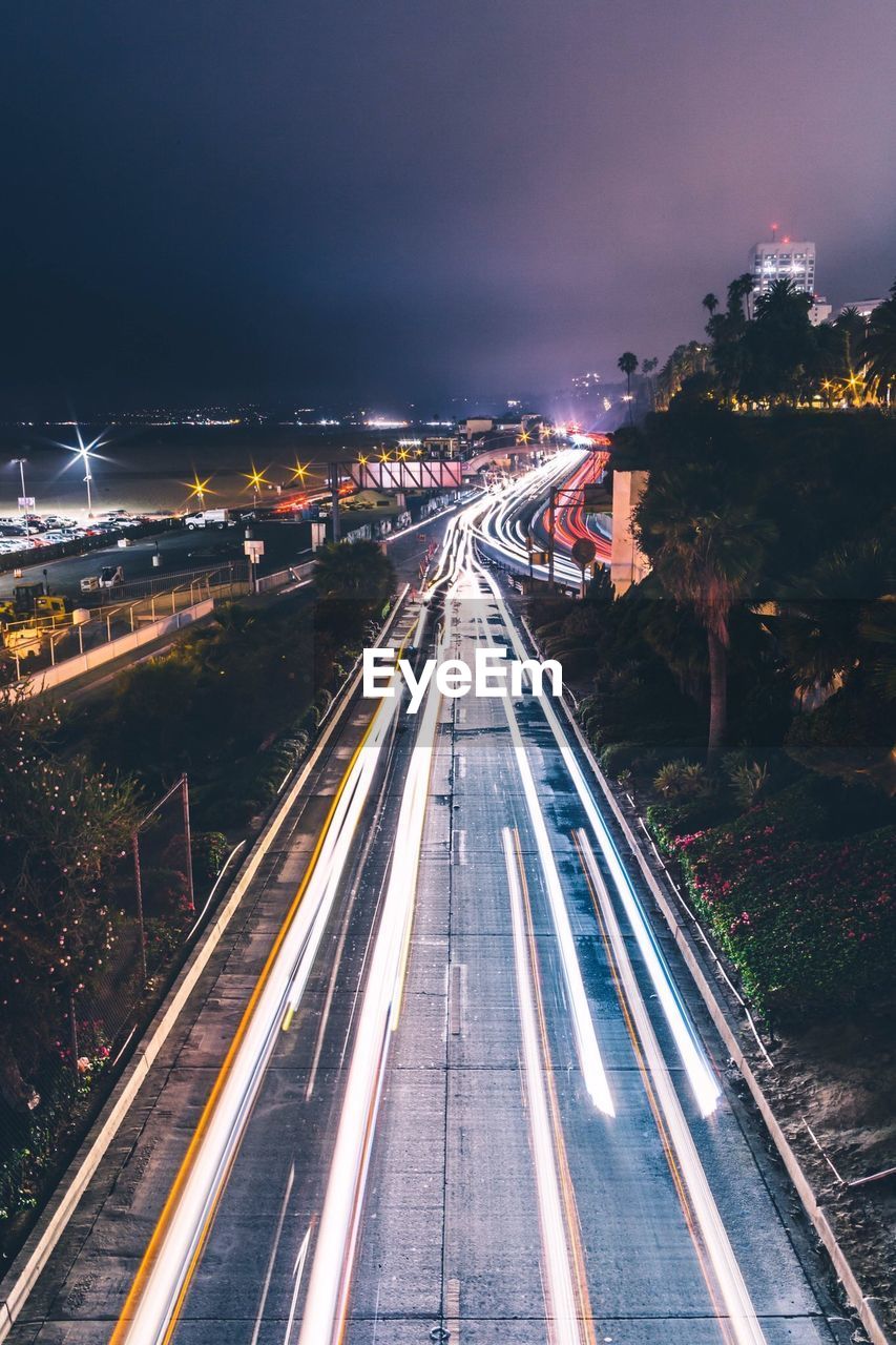 High angle view of light trails on highway at night