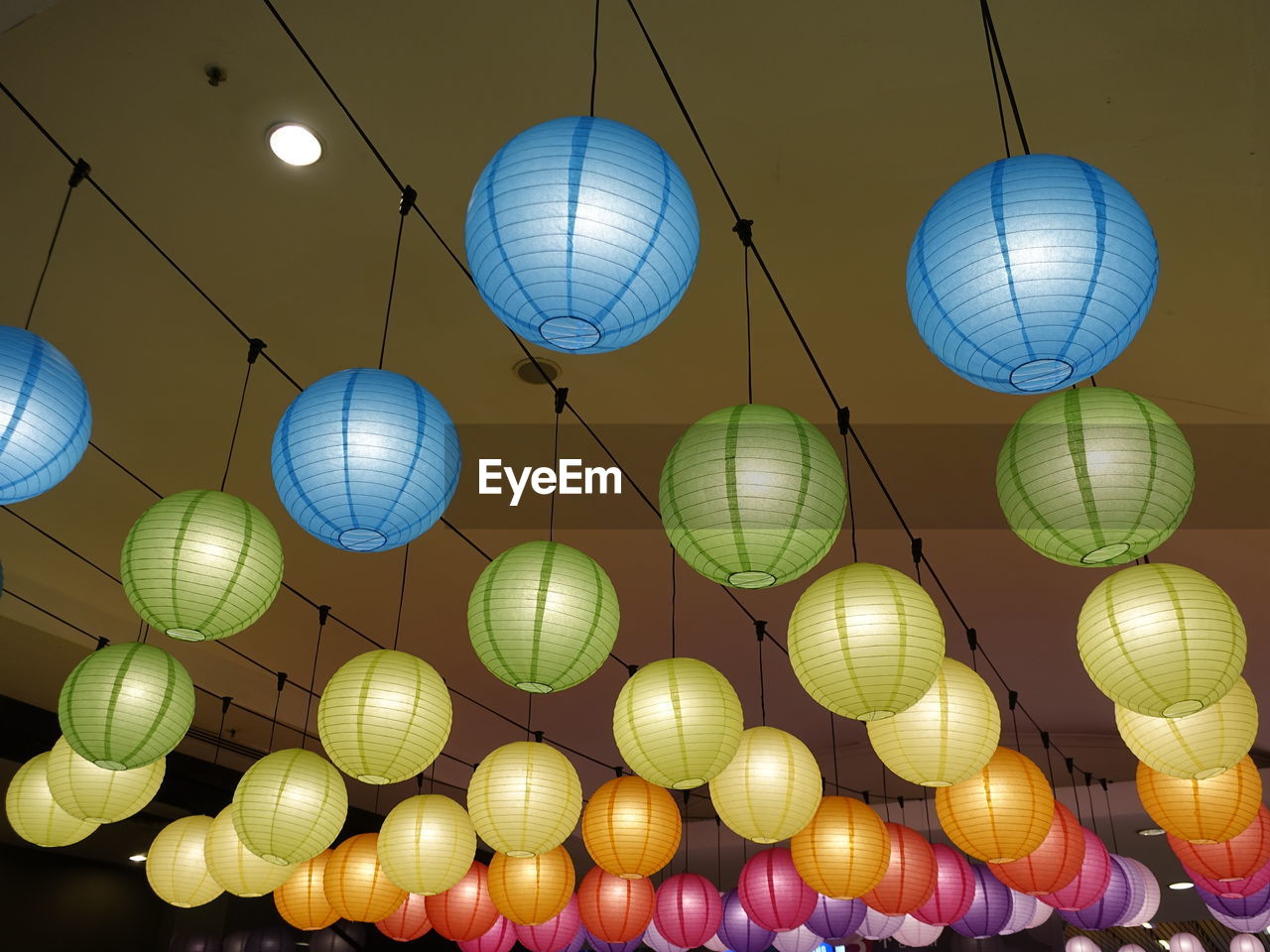 LOW ANGLE VIEW OF LANTERNS HANGING ON CEILING